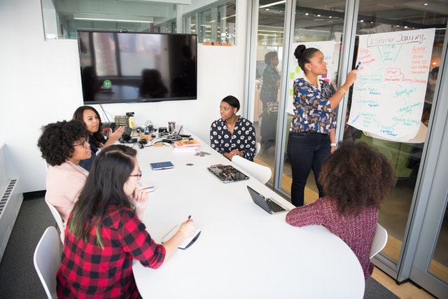 six-woman-standing-and-siting-inside-the-room-1181622 